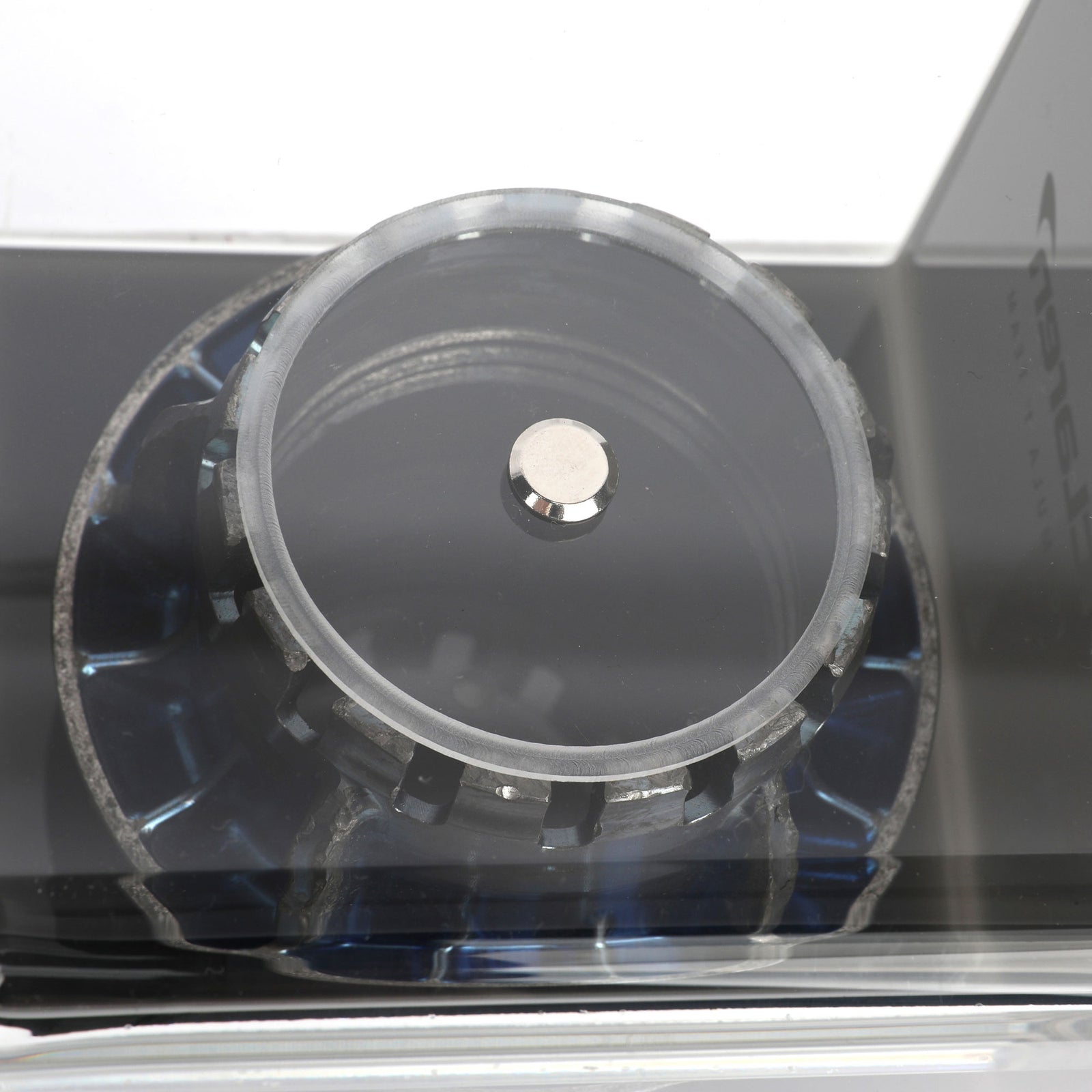 Authentic McLaren F1 Team 2025 blue wheel nut presented in a premium display case for collectors