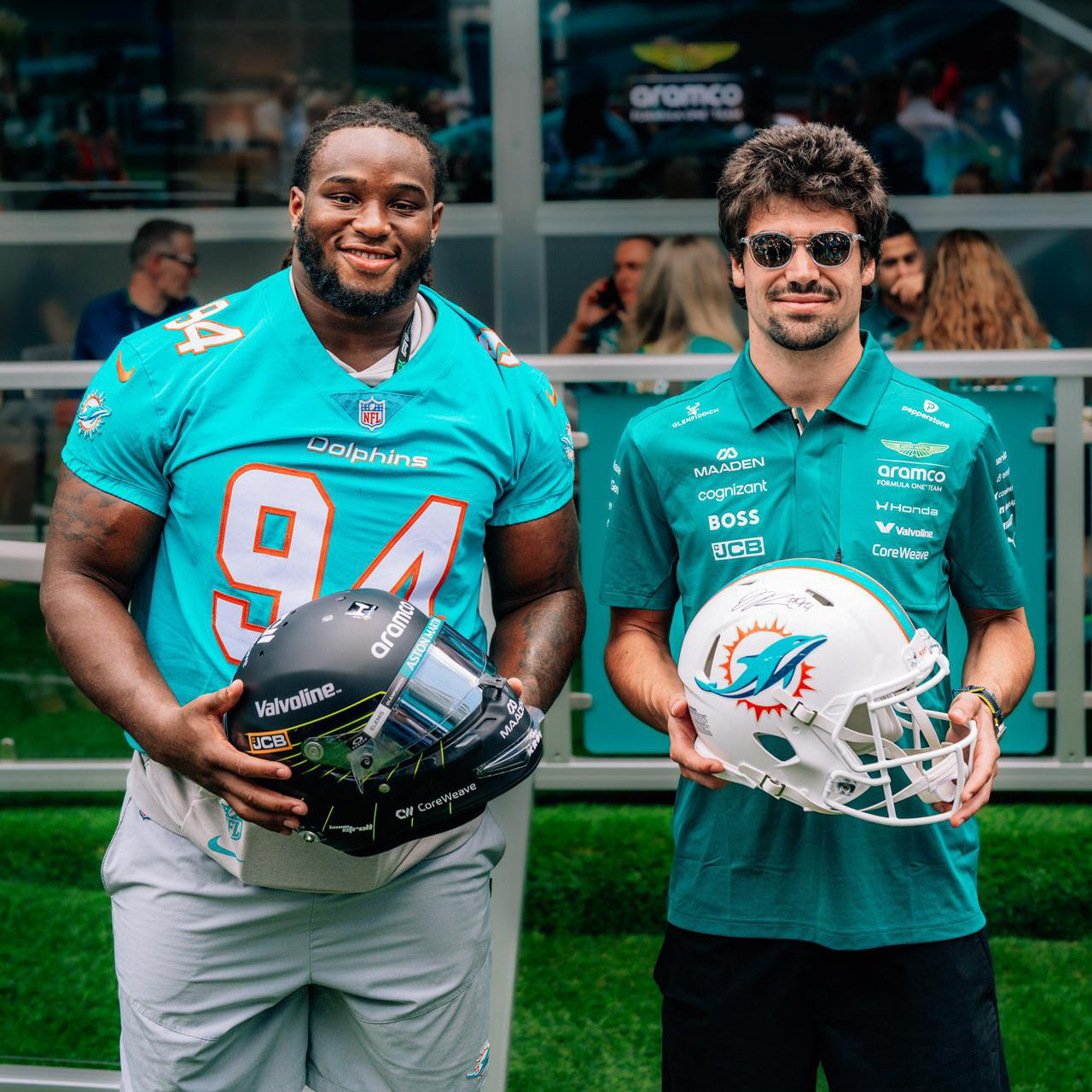 Aston Martin Aramco Formula One™ Team x Miami Dolphins Lance Stroll Signed Helmet Jordan Phillips Signed Football Helmet presented Atlas Air Worldwide