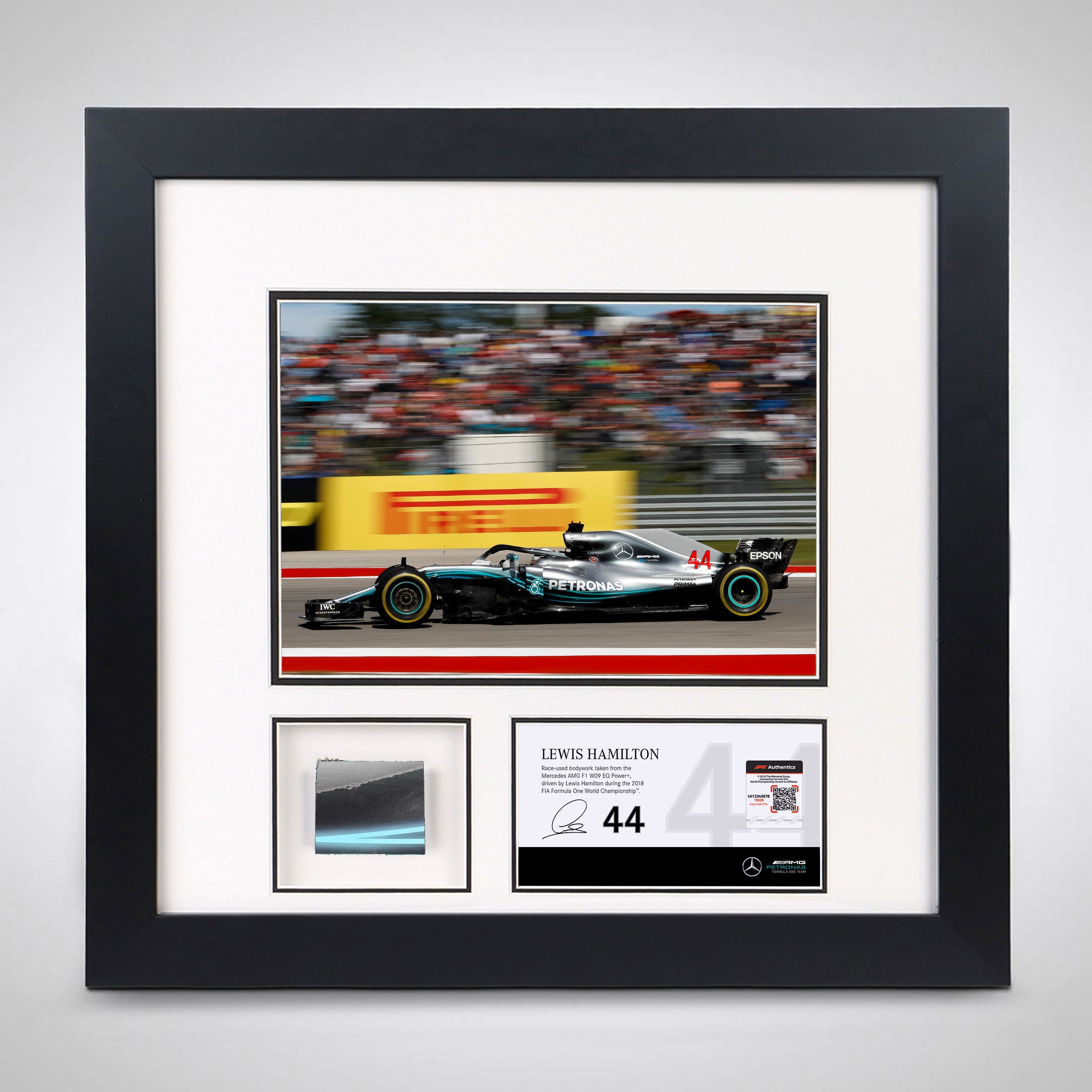 Picture frame with a piece of Lewis Hamilton's race car and photo racing at the 2018 US Grand Prix