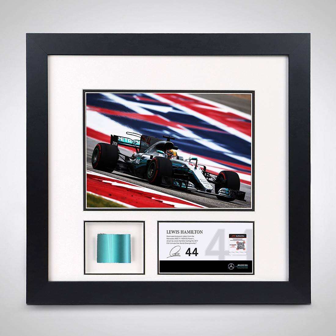 Framed picture of Lewis Hamilton racing in US Grand Prix with a piece of bodywork from car shown 